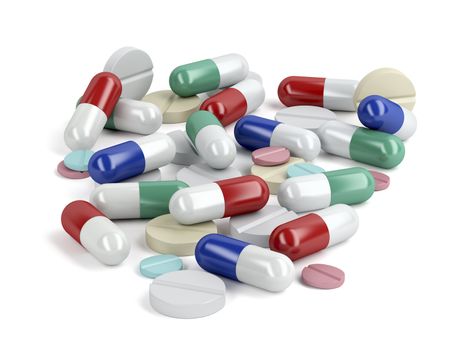 Pile of pills and capsules on white background