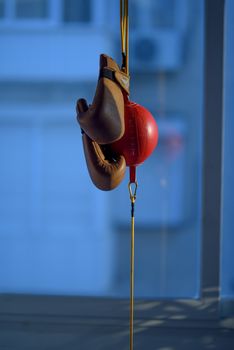 Boxing ball, punch ball in red color with boxing gloves