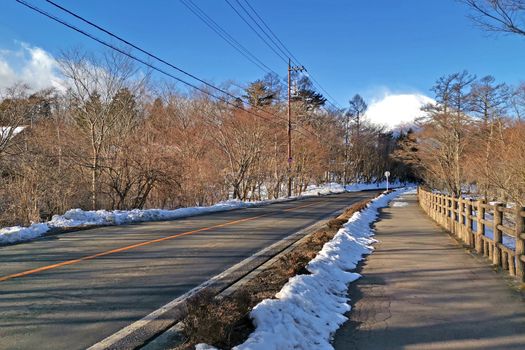 The road, sky and Fuji mountain with snow in Japan countryside
