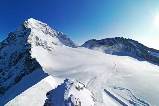 The peak of Switzerland Grindelawld snow mountain with blue sky
