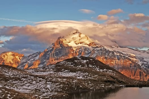 The snow mountain, clouds, blue sky, lake in Switzerlnd park