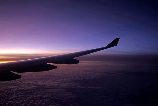 The plane, aeroplane wing, clouds,  gradient sky from aerial view