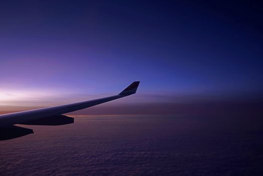 The plane, aeroplane wing, clouds,  gradient sky from aerial view