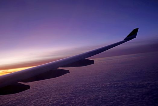 The plane, aeroplane wing, clouds,  gradient sky from aerial view