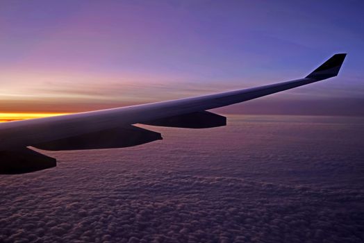 The plane, aeroplane wing, clouds,  gradient sky from aerial view