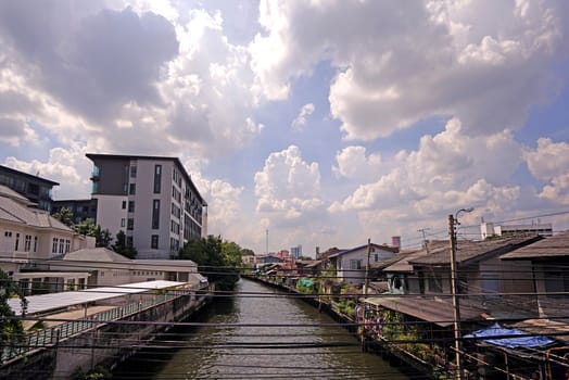 The Thailand residential apartment, river, footpath and tree at daytime
