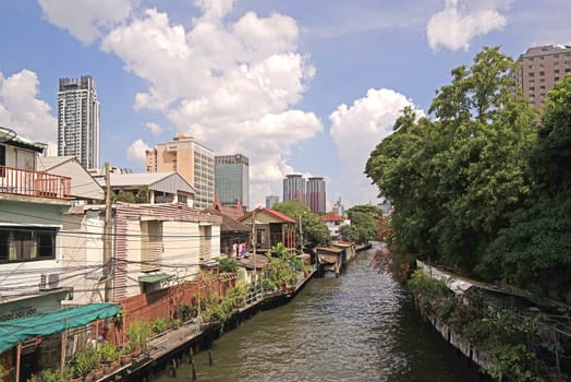 The Thailand residential apartment, river, footpath and tree at daytime
