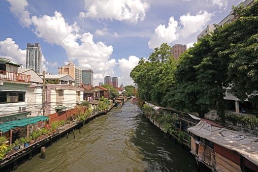 The Thailand residential apartment, river, footpath and tree at daytime
