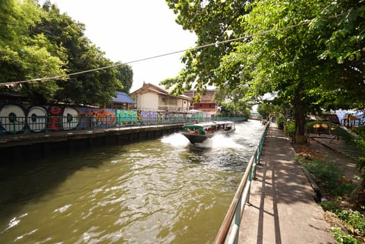 The Thailand tourist canal boat on village river at daytime