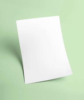 The white blank document paper template with green background