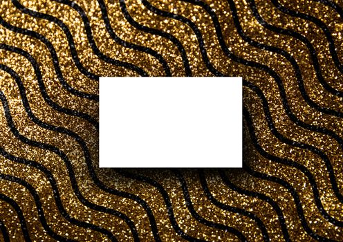 The business card mock-up template with gold glitter wavy line pattern fashion dark paper background