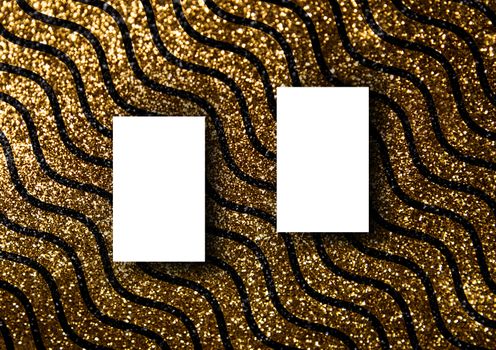 The business card mock-up template with gold glitter wavy line pattern fashion dark paper background