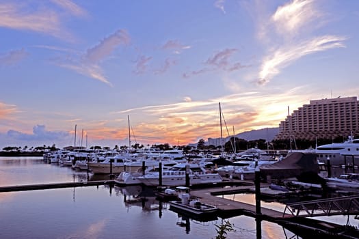 The luxury yacht, pier; building, cloudscape,, gradient sky at sunset