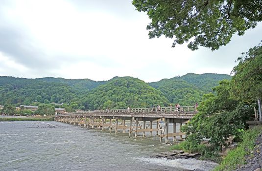 The traditional bridge, footpath, mountain, wooden bridge, rapid river in Japan Kyoto