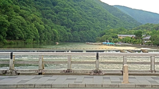 The traditional bridge, footpath, mountain, wooden bridge, rapid river in Japan Kyoto