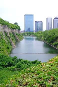 The Japan Osaka landmark historical castle architectural with commerical building in downtown