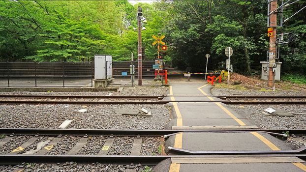 The outdoor train track with traffic alert light in Japan countryside