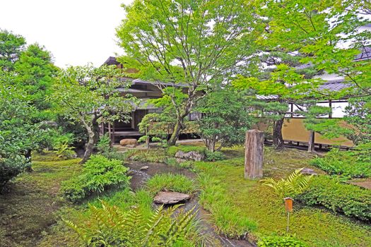 The outdoor footpath, green plants and pavilion in the Japanese zen garden