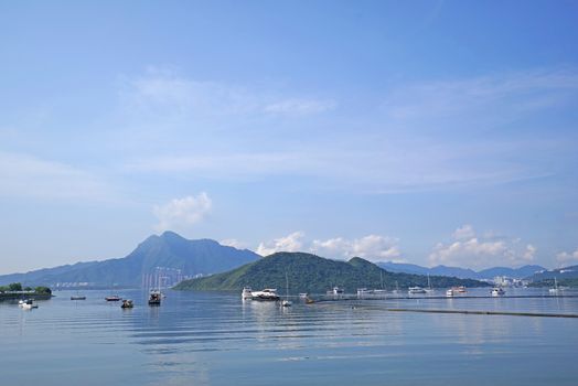 The yacht, fishing and recreational boats on lake and mountains