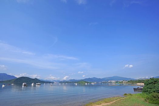 The yacht, fishing and recreational boats on lake and mountains