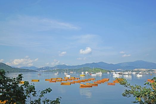 The orange recreational boats on lake, mountains and tree