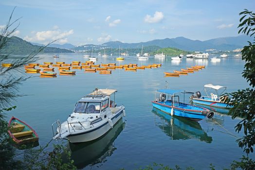 The yacht, fishing and recreational boats on lake and mountains