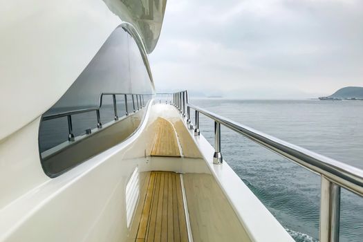 The wooden aloft and glass with reflection in white luxury yacht