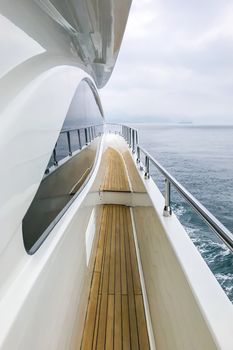 The wooden aloft and glass with reflection in white luxury yacht