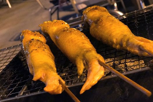 Outdoor barbecue chicken wing on the metal net grilled