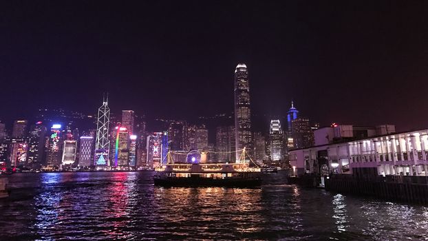 architectural building and Victoria River in Hong Kong city at night