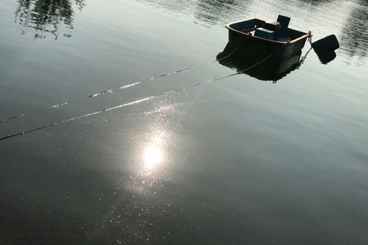 Fishing boat with reflection on the lake