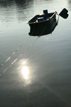 Vertical fishing boat with reflection on the lake