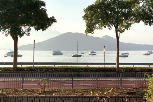 footpath, mountain, tree, boat, sky and the ocean