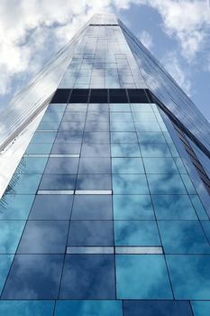 Commercial building in downtown district with the cloud reflection