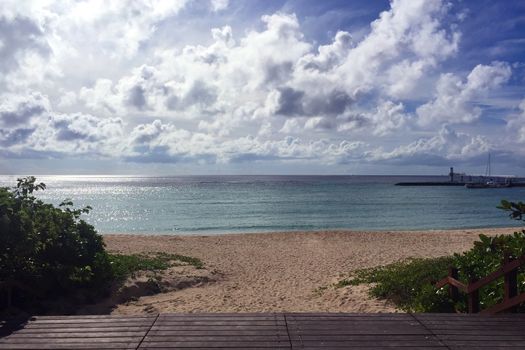 Beach, ocean, blue sky and wooden stage 