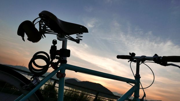 The silhouette of retro bicycle and the sunset