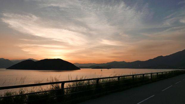 The silhouette of plant, road and frame with the gradient sunset