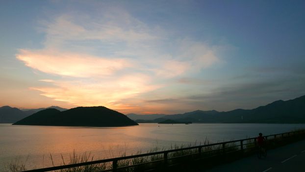 The silhouette of plant, road and frame with the gradient sunset