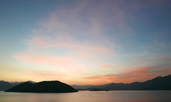 The silhouette of mountain with the cloud and gradient sunset