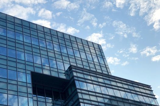 Commerical office building with the reflection of blue sky and cloud