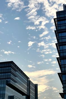 Commerical office building with the reflection of blue sky and cloud