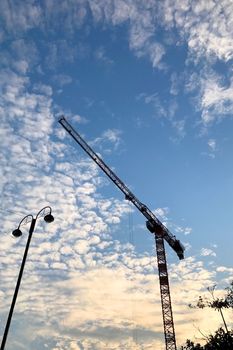 silhouette of building construction and street lamp with blue sky