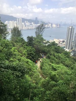 Hiking people in mountain footpath with the building