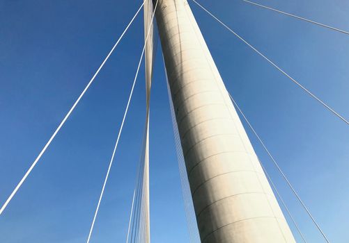 Part of the bridge building and the blue sky from bottom angle