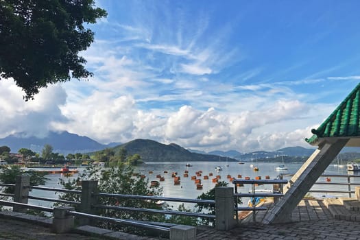 The mountain, blue sky, boats, yacht and sailboats near the park