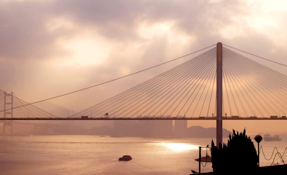 The silhouette of Hong Kong highway bridge building before sunset