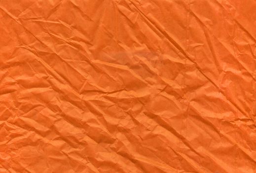 The Halloween orange crumpled and grungy textured blank paper background