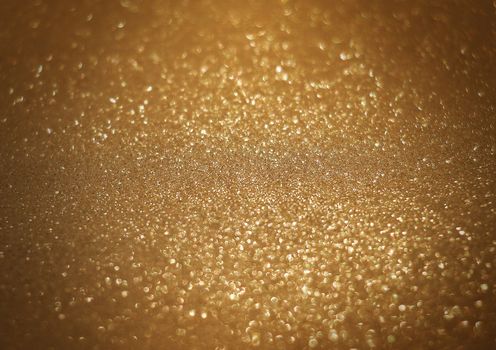 The sparkle bright glittering golden abstract background