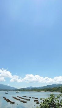 Vertical recreational Boat, lake, white cloud and the blue sky