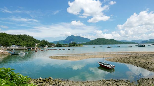 Recreational fishing Boat, lake, white cloud and the blue sky